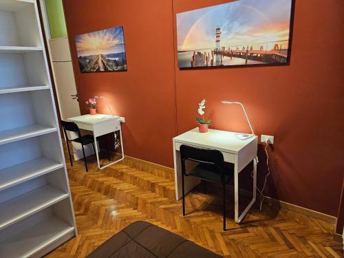 a room with two desks and a shelf at 2 letti singoli a linea M1 Sesto Rondo' in Sesto San Giovanni