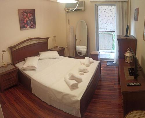a bedroom with a bed with towels on it at Comfortable apartment 200 m from the sea in Piraeus