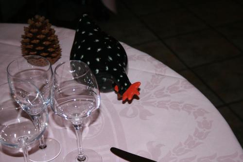 a table with wine glasses and a hat on it at Auberge De L'Atre in Quarré-les-Tombes