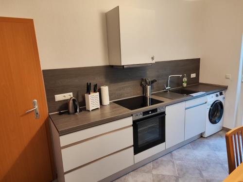 a kitchen with a sink and a washing machine at FeWo Bismarck 29 in Stendal