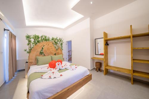 a bedroom with two dolls sitting on a bed at Terra Ares in Kayakoy