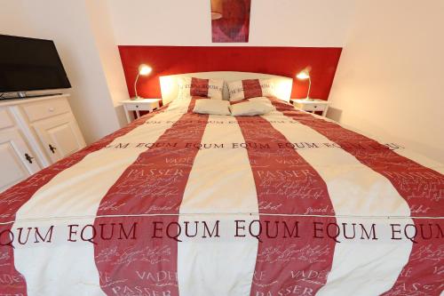 a bedroom with a large bed with a red headboard at Haus Elise in Füssen