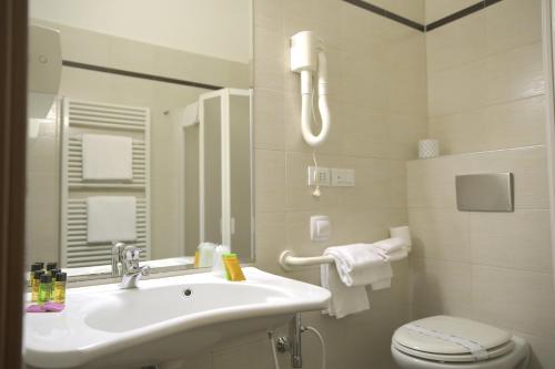 a bathroom with a sink and a toilet at Verdemilia Hotel in Anzola dell'Emilia