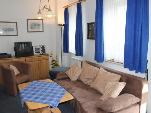 a living room with a couch and a table at Beautiful Apartment in Rerik with Garden near Sea in Rerik