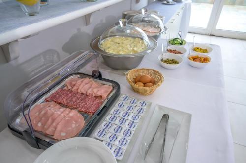 a kitchen counter with meat and eggs and other foods at Hotel Centro Congressi Polo Nautico in Salerno