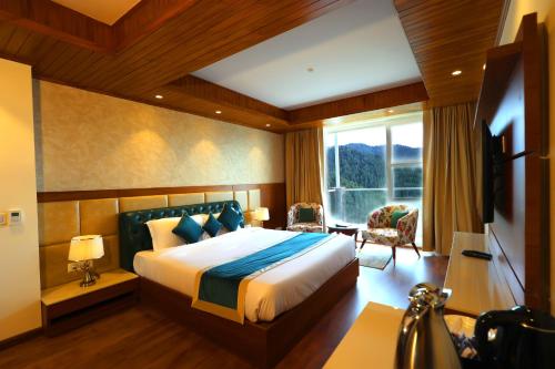 a bedroom with a large bed and a window at The Retreat Mashobra, Shimla in Shimla