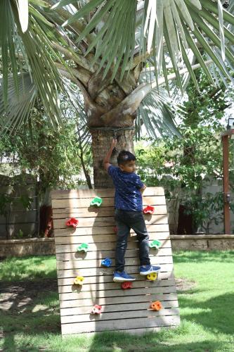 a young boy standing on a skateboard on a box at The Fern Gir Forest Resort, Sasan Gir - A Fern Crown Collection Resort in Sasan Gir