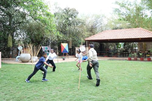 a group of people playing a game of frisbee at The Fern Gir Forest Resort, Sasan Gir - A Fern Crown Collection Resort in Sasan Gir