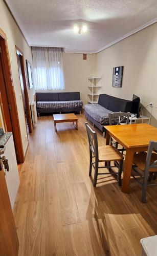 a living room with a couch and a table at Apartamentos Laredo-Playa in Laredo