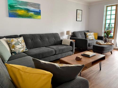 a living room with a couch and a coffee table at Hydeaway beautiful 3 bedroom house in a great location in Bournemouth