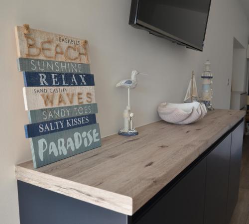 a kitchen counter with a wooden counter top at Swn Y Mor - Sound of the Sea - by Aberporth Beach Holidays in Aberporth