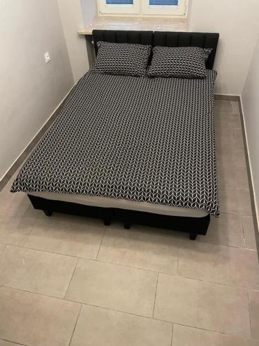 a black bed in a room with a tile floor at Hotels-Widok Rynek - Centrum &Parking -fak VAT in Kielce