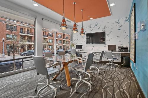 a dining room with a table and chairs at CozySuites Mill District with pool, gym #02 in Minneapolis