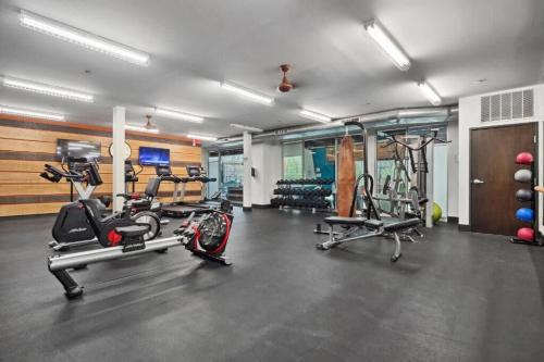a gym with several treadmills and exercise bikes at CozySuites Mill District with pool, gym #02 in Minneapolis