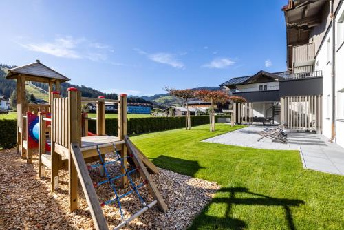 a playground in the yard of a house at Aparthotel Jägerheim in Flachau