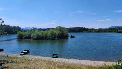 two boats sitting on the shore of a lake at Drevenička Rybička in Liptovský Trnovec