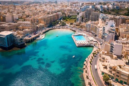 an aerial view of a city with a harbor at Brand New St. Julian's Luxury Apartment - Wish Malta in St. Julianʼs