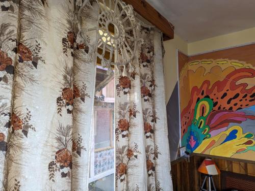 a curtain in a room with a window at Ikigai Manali in Nagar