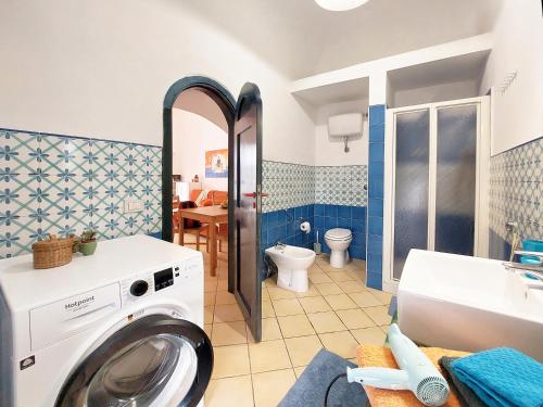 a washing machine in a bathroom with a sink at Forio Family Home in Ischia