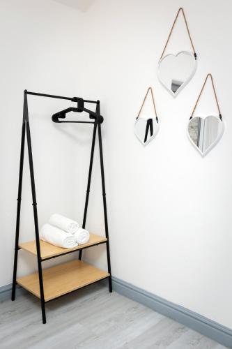 a black lamp on a shelf next to a white wall at Comfortable 3 Bedrooms Leeds Beach House - Ideal for Family and Contractors - Free WIFI, Projector in bedroom and Free Parking for 2 cars in Killingbeck