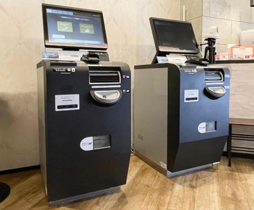 two atm machines with a laptop on top of them at Hotel Classe Stay Sapporo in Sapporo