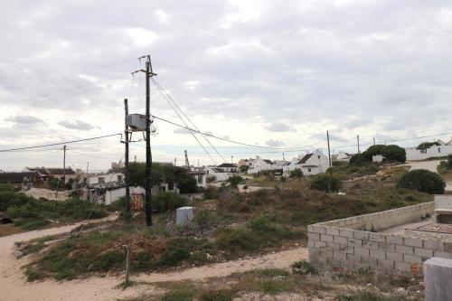 a view of a town from a hill with houses at House 15 A Kassiesbaai in Arniston