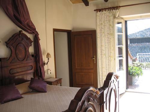 a bedroom with a bed and a large window at Antica Torre in Salsomaggiore Terme