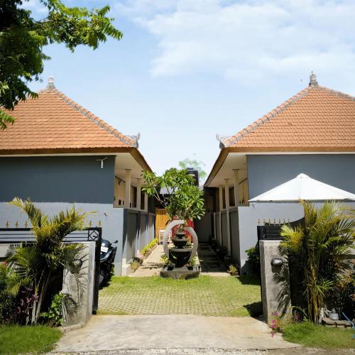 a house with a gate in front of it at Guest House 88 Pandawa in Nusa Dua