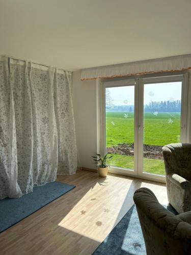 a living room with a large window and a couch at Netter Ferienhaus in Bockenem