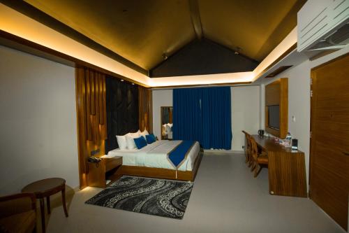 a hotel room with a bed and a bathroom at Shaira Garden Hotel & Resorts in Nārāyanganj