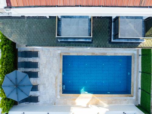 an overhead view of a swimming pool with a blue umbrella at Villa Tutar 2 in Marmaris
