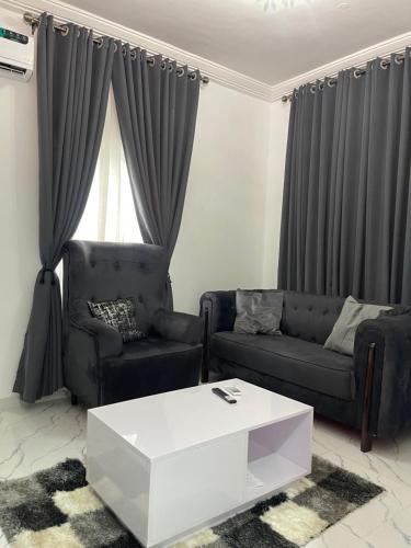 a living room with a couch and a coffee table at Blueocean.cog Apartments in Benin City