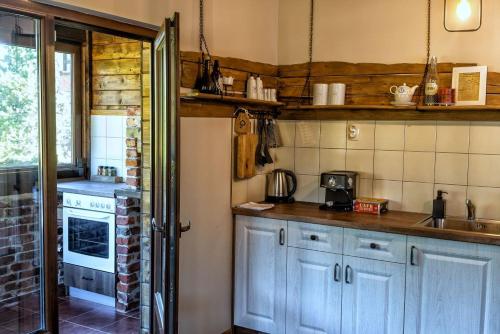 a kitchen with blue cabinets and a sink and a stove at Вила Приказка in Tsar Kaloyan
