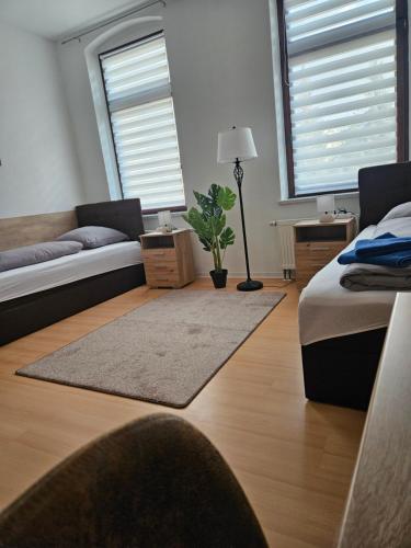 a living room with a bed and a couch at Ferienwohnung WESTEND in Plauen