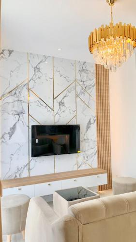 a living room with a couch and a marble wall at Montage Villa near Beach with Golf View in Nongsa