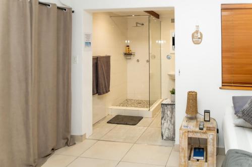 a bathroom with a shower with a shower curtain at The Little Gem in Clanwilliam