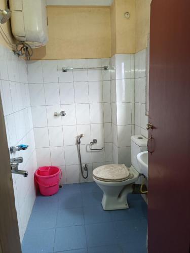 a bathroom with a toilet and a shower in it at Hotel Orchid in Guwahati