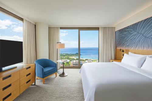 um quarto de hotel com uma cama e uma televisão em Renaissance Residences Oahu Honolulu em Honolulu