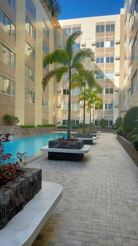 a courtyard with palm trees in front of a building at Stanford Suites 2 in Cavite