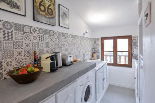 a kitchen with a counter with a bowl of fruit on it at LE PETIT BATEAU - NEW cosy/charming studio/mezzanine for 3 - AC/WIFI in Antibes