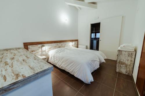 a white bedroom with a bed and a mirror at Hotel Alla Sosta in Rezzato