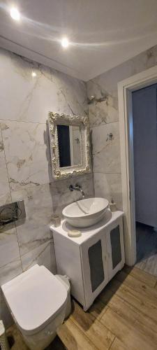 a bathroom with a toilet and a sink at Seva's House in Psinthos