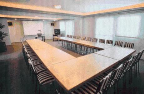 a large conference room with a long table and chairs at Flat Saint Paul Residence in Bauru