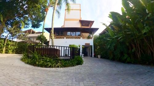 a building with a clock tower on top of it at Hotel Natur Campeche in Florianópolis