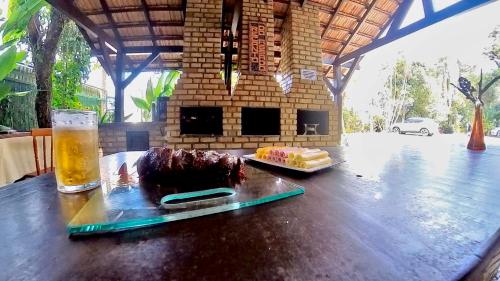 a table with a cake and a glass of beer at Hotel Natur Campeche in Florianópolis