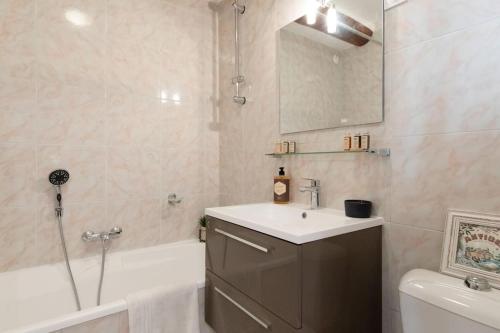 a bathroom with a sink and a tub and a mirror at LA PAIA - BRAND NEW FLAT 3 Guests OLD TOWN 5 min. from beach in Antibes