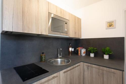 a kitchen counter with a sink and a microwave at LA PAIA - BRAND NEW FLAT 3 Guests OLD TOWN 5 min. from beach in Antibes