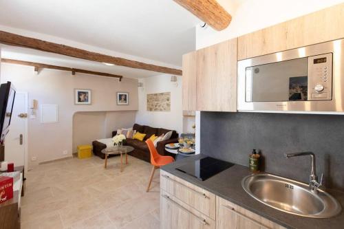 a kitchen with a sink and a living room at LA PAIA - BRAND NEW FLAT 3 Guests OLD TOWN 5 min. from beach in Antibes