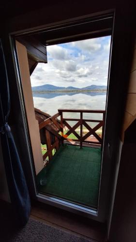 a window with a view of a body of water at O.W. MEGA nad jeziorem in Żywiec