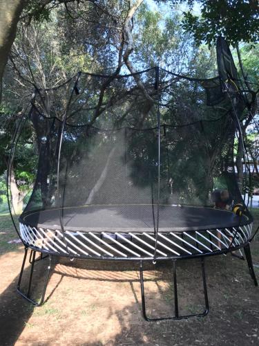 a swing in a park with a canopy at Kruger Park Farmstay near Orpen Gate in Hoedspruit